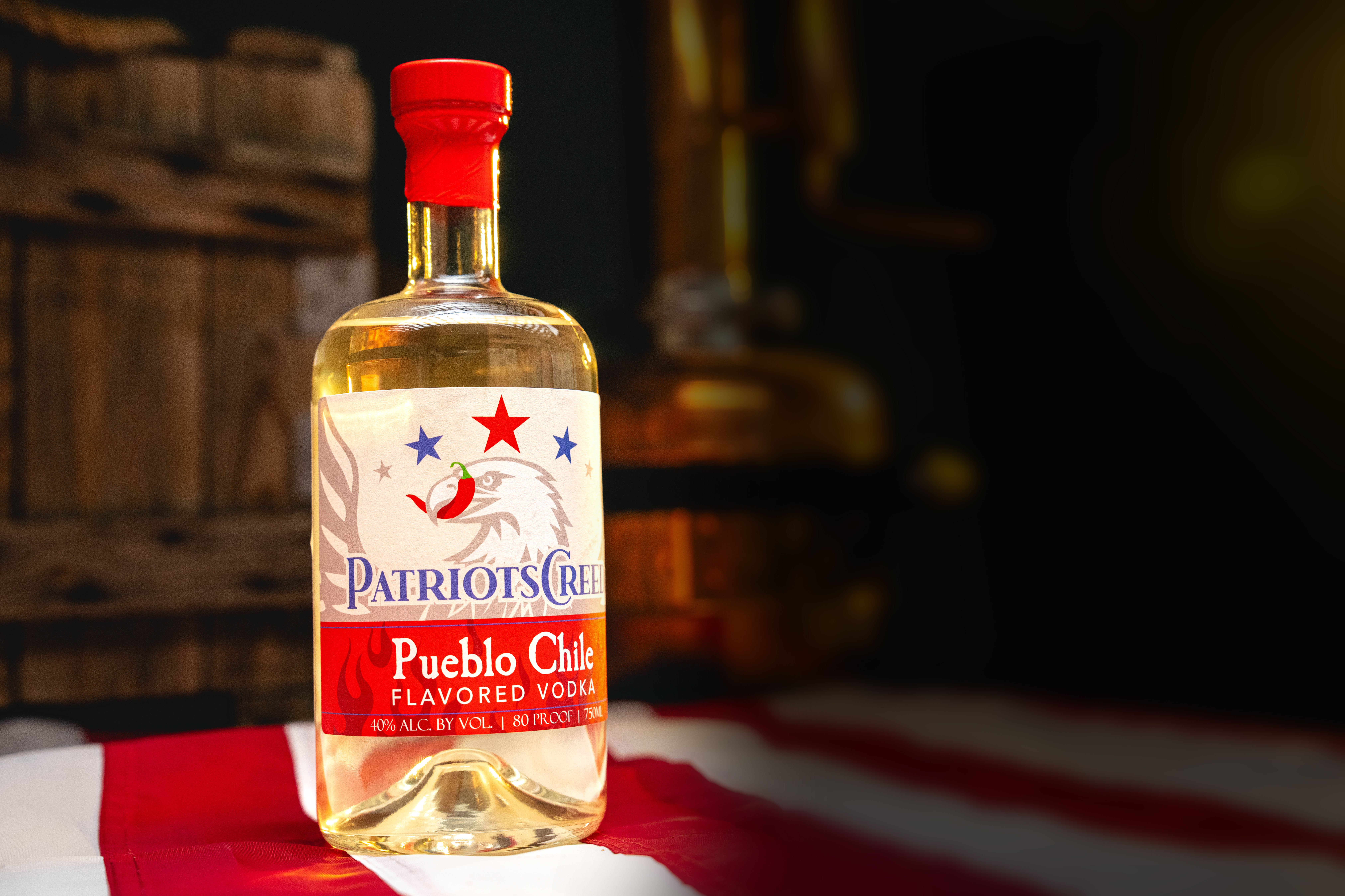 Patriot's Creed Vodka: Pueblo Chile Bottle - Professionally photographed. Sitting atop an American flag.